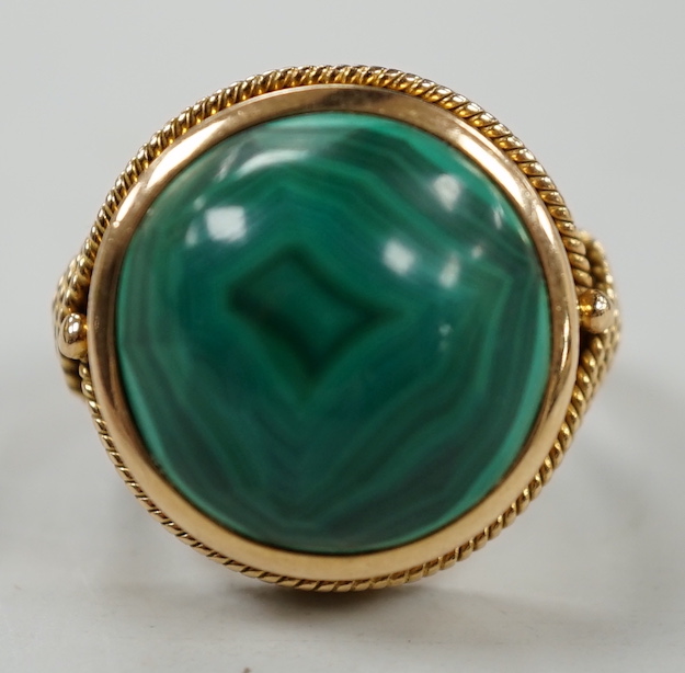 A yellow metal and cabochon malachite set dress ring, size F/G